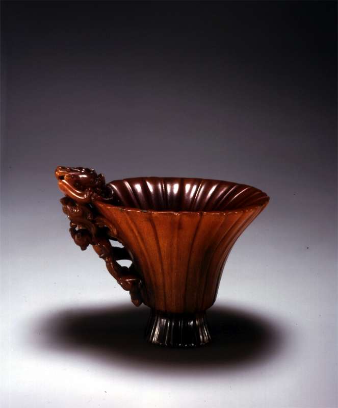 Flower-shaped cup with a handle in the form of a dragon